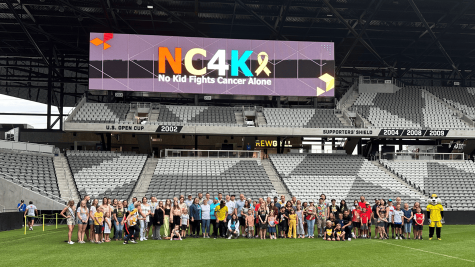 NC4K families and supporters gather at a stadium event, symbolizing community impact supported by NewOrg’s case management platform.